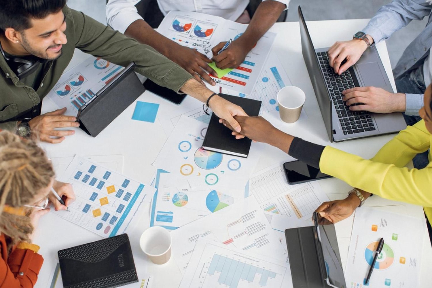 Compliance analysts reviewing due diligence reports and ownership charts in a Dubai office