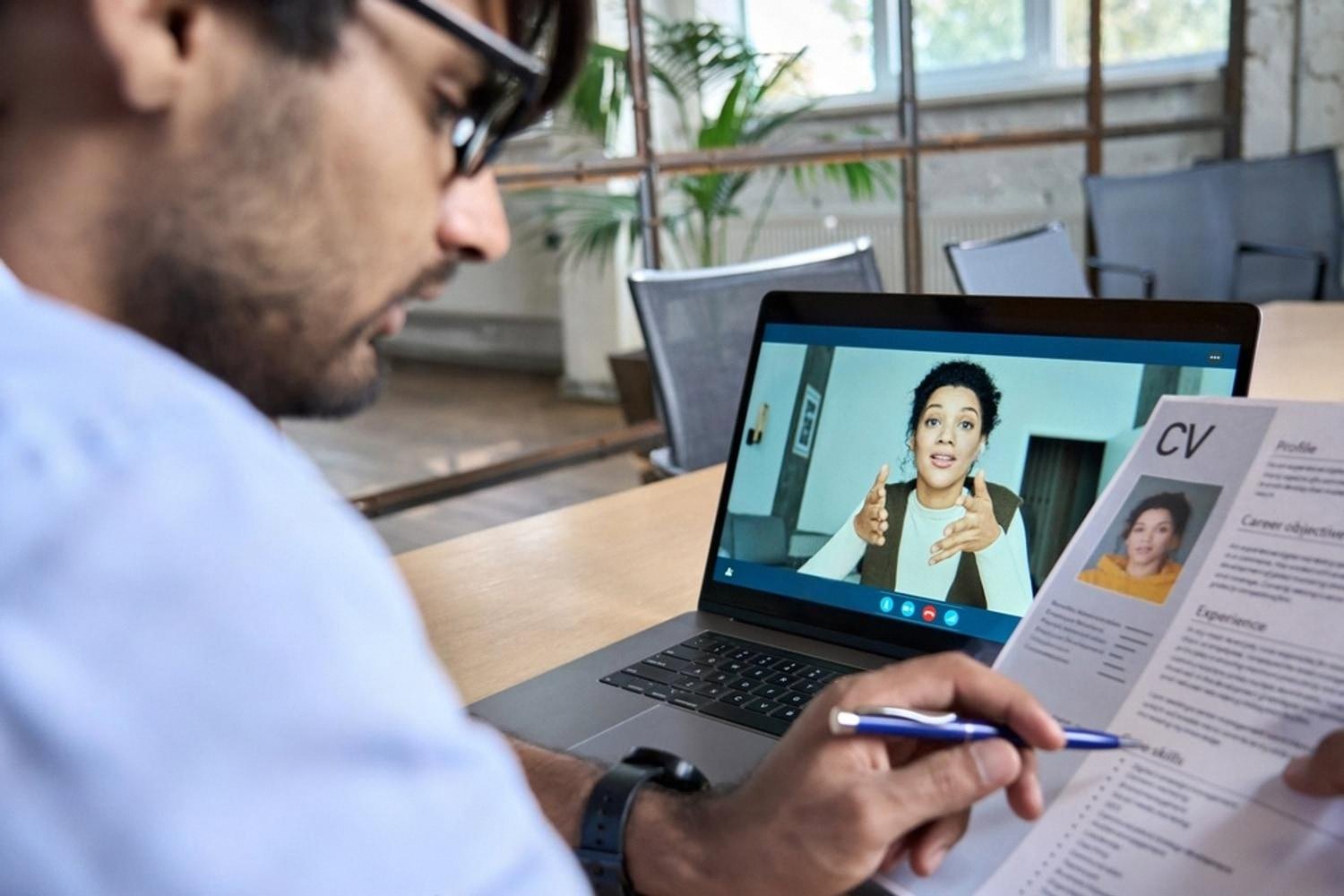 HR consultant conducting a remote candidate interview and reviewing a CV in the UAE