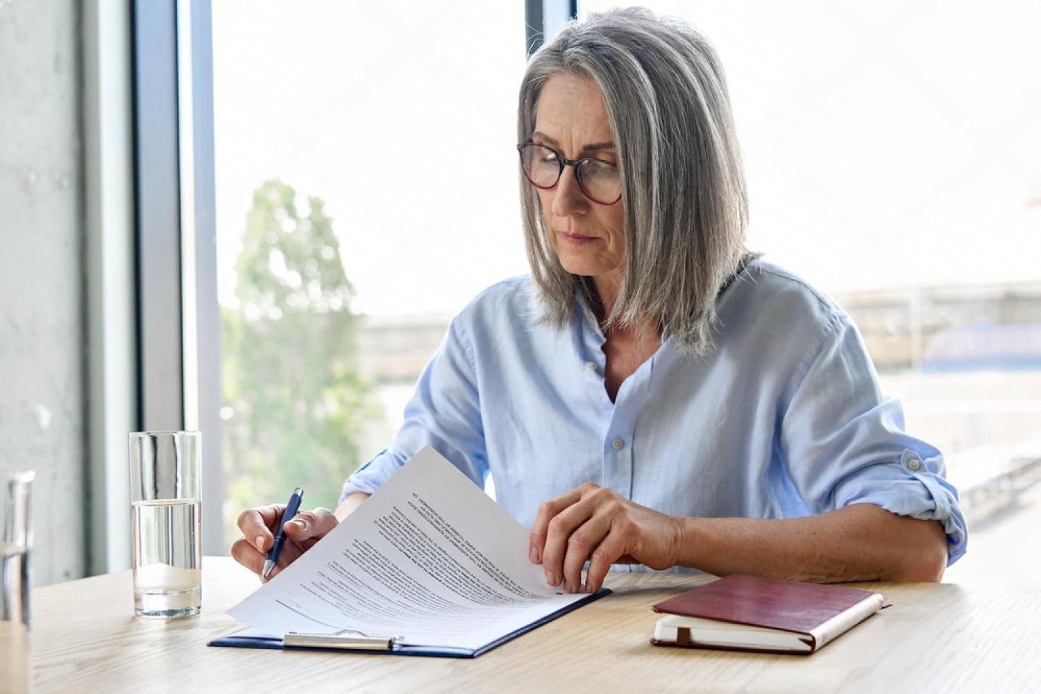 Senior HR consultant reviewing an employment contract at a Dubai office desk